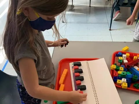 a girl playing with a toy