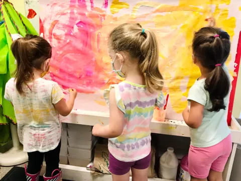a group of young girls painting