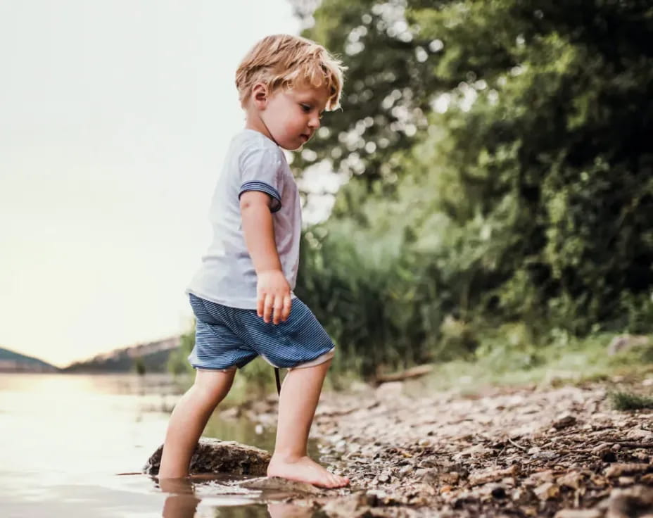a child standing in a puddle