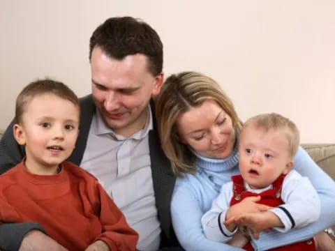 a family sitting on a couch