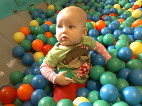 a baby in a ball pit