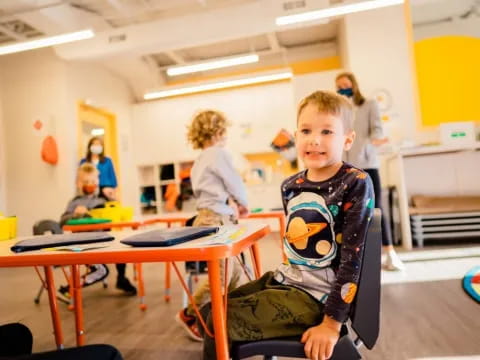 a boy sitting at a desk
