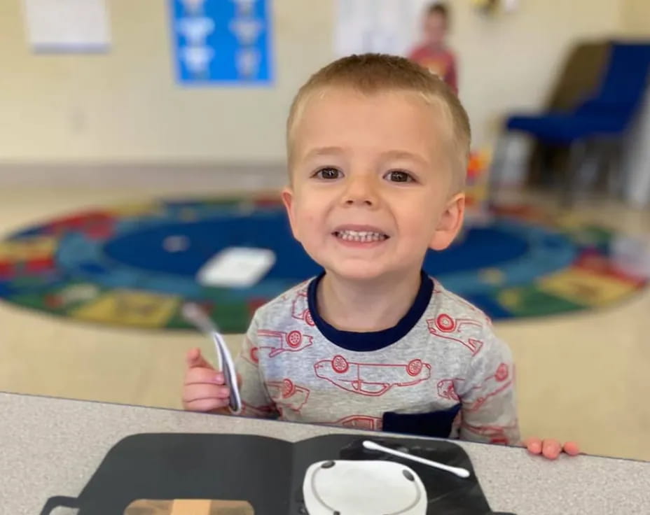 a baby sitting at a table