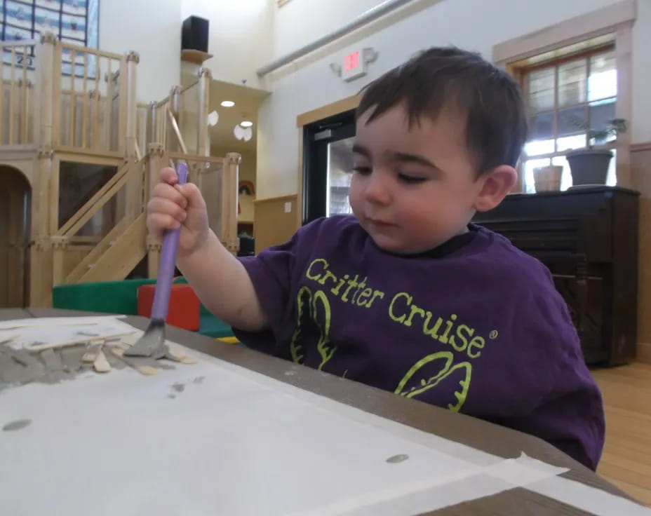 a boy painting on a table