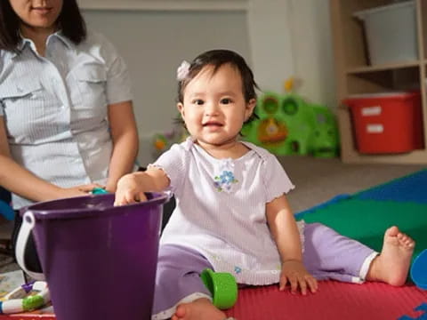 a baby sitting on the floor