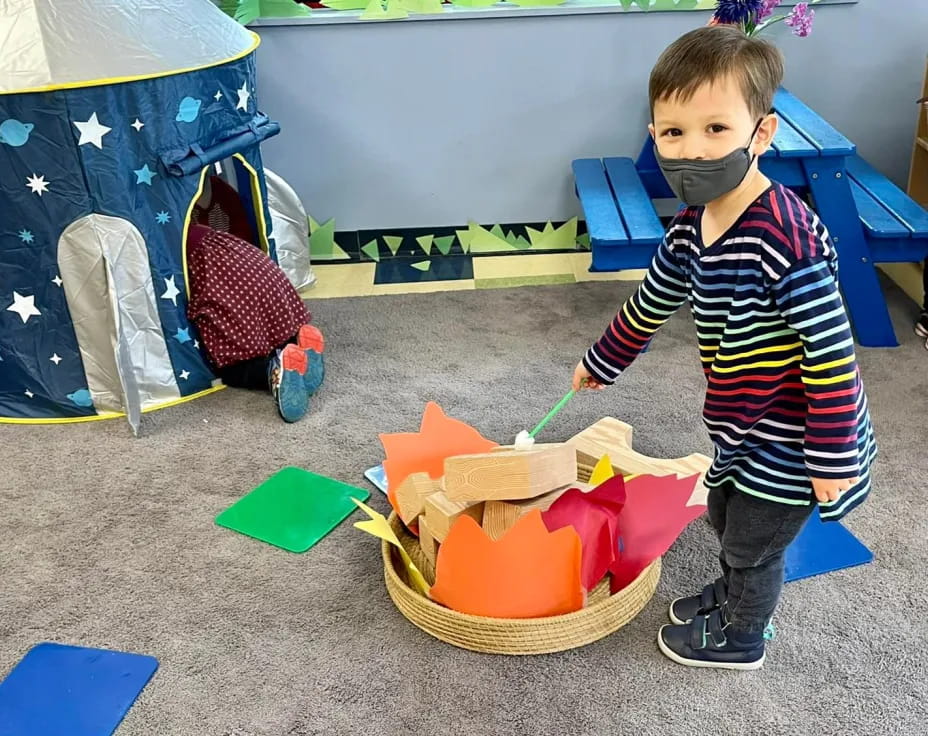 a boy holding a toy