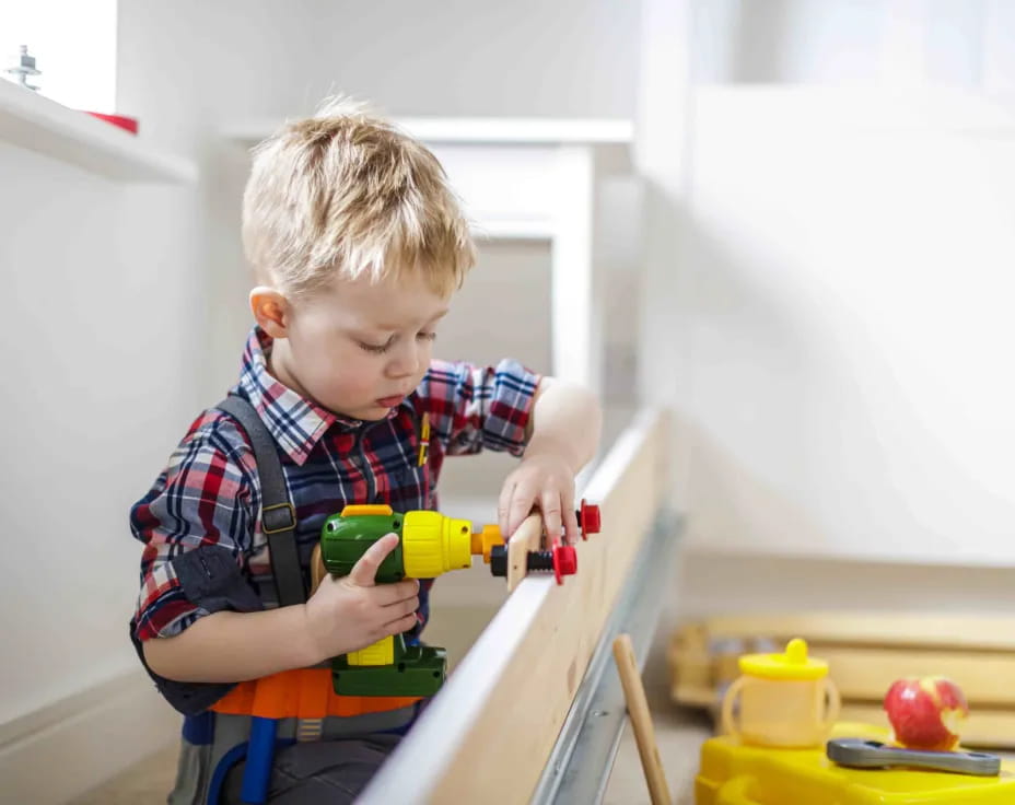 a boy playing with a toy