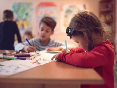 a few children sitting at a table