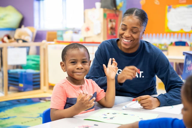 a person and a boy sitting at a table