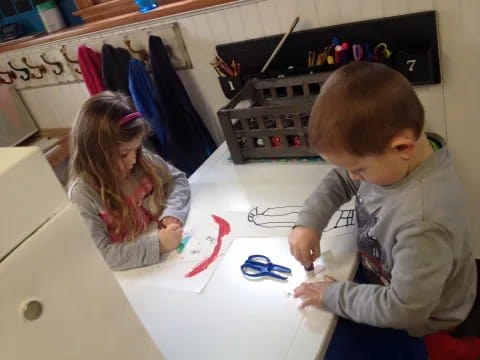 a boy and girl playing with a toy