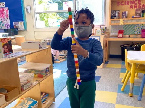 a young boy holding a toy sword