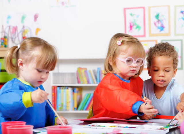 a group of children sitting at a table