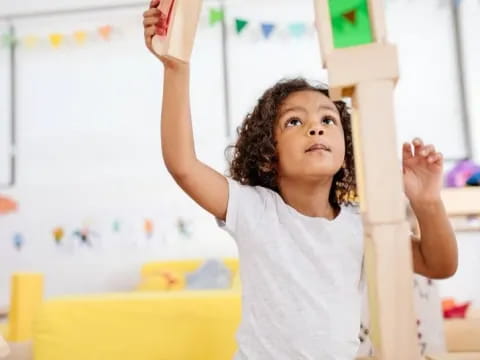 a young girl raising her hands