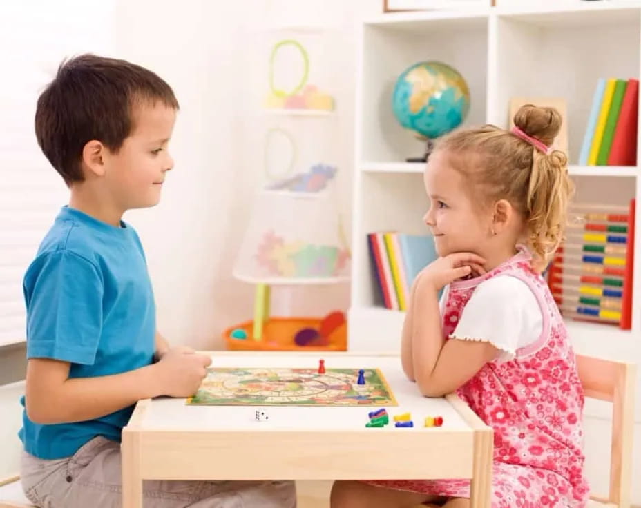 a boy and girl playing a board game