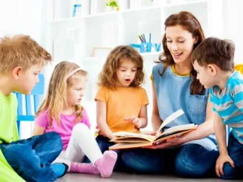 a group of children reading a book