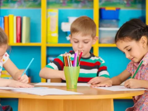 a few children sitting at a table