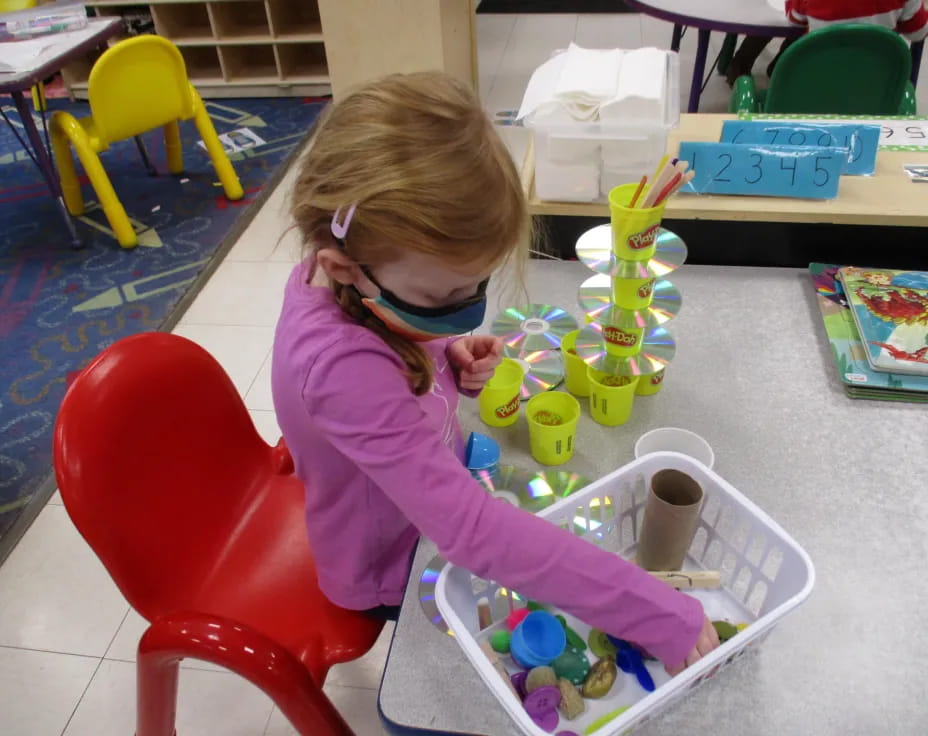 a girl painting on a table