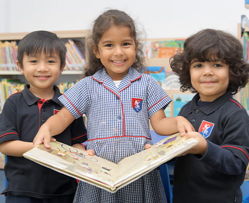 a group of children holding a book