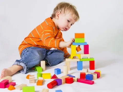 a baby playing with blocks