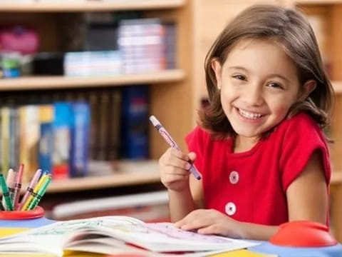 a young girl writing on a book