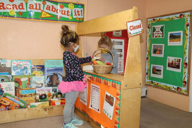 a young girl holding a basket