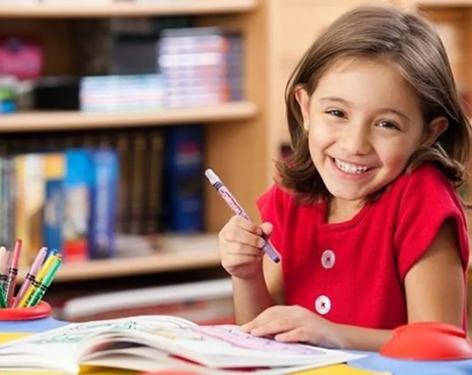 a young girl writing on a book