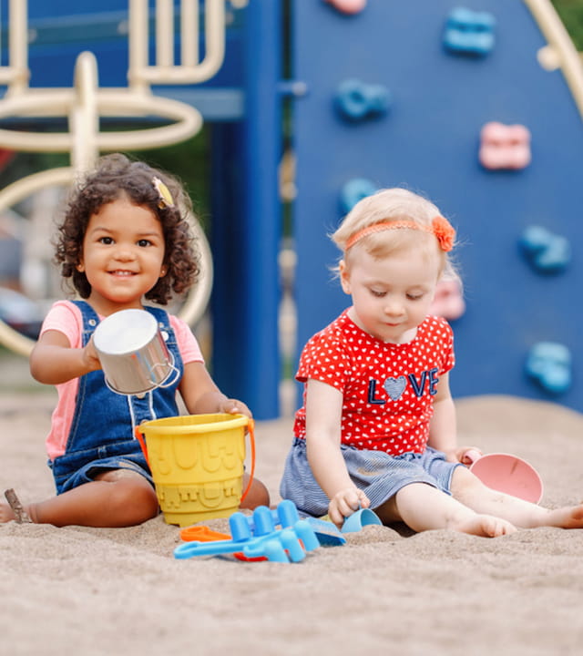 two children sitting on the ground