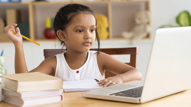 a young girl working on her laptop