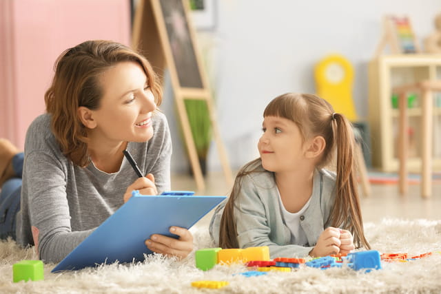 a couple of young girls playing with a toy