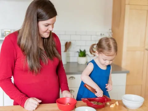 a woman and a child preparing food