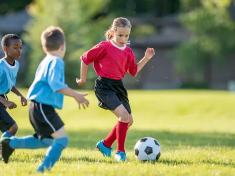 kids playing football on a field