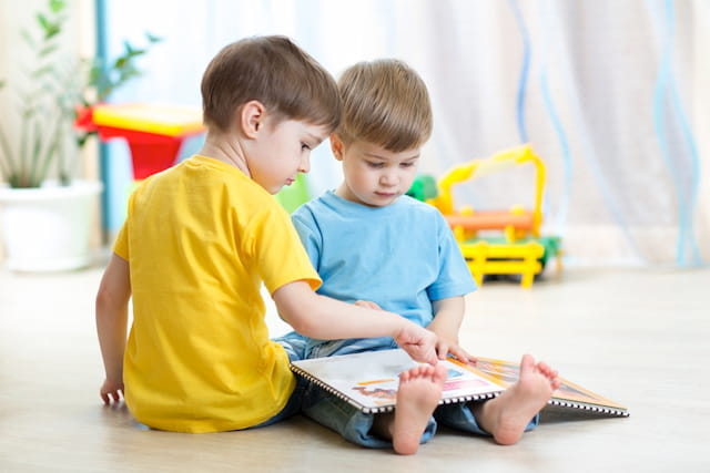 two boys sitting on the floor