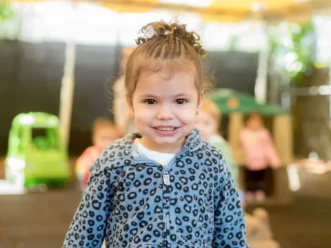 a little girl with a ponytail