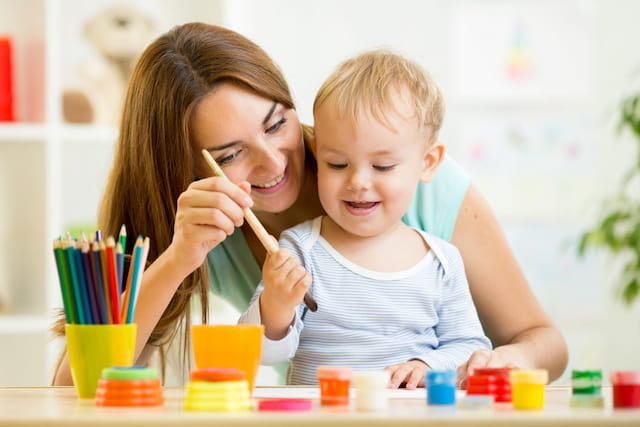 a person and a child painting