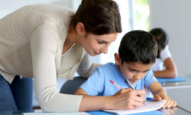 a person and a boy looking at a book