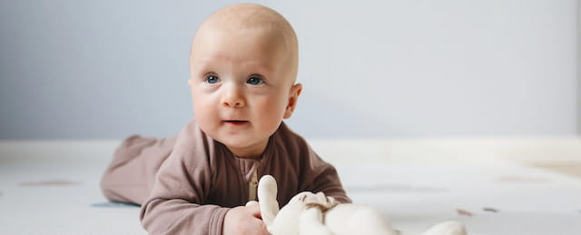 a baby holding a piece of food