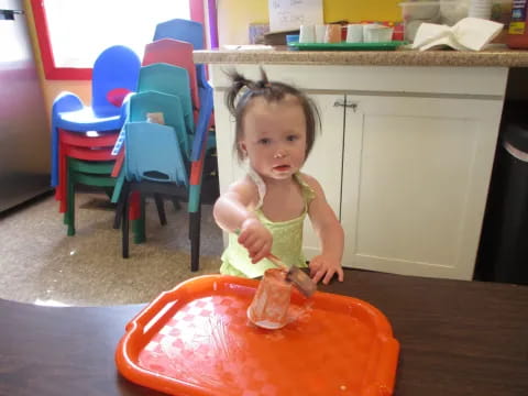 a little girl eating a cake