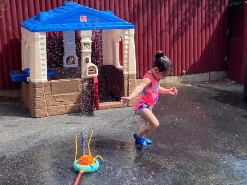 a girl playing with a toy