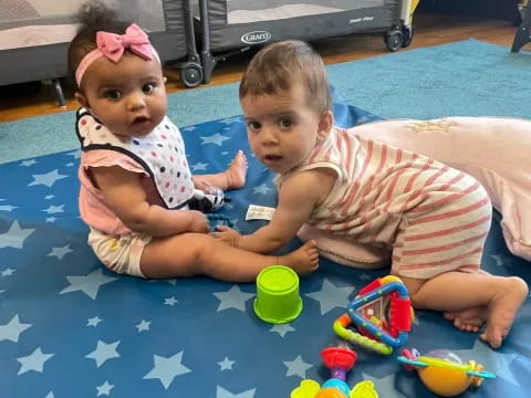 two children lying on the ground