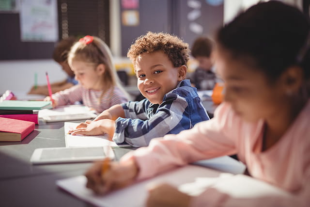 a few children sitting at a table