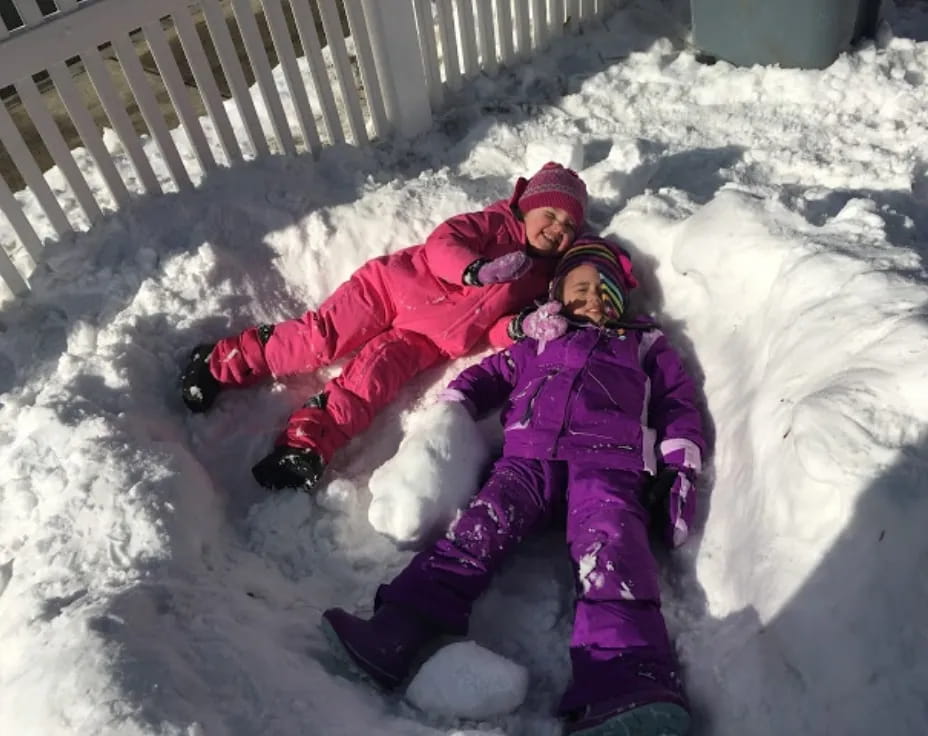 a person and a child in the snow