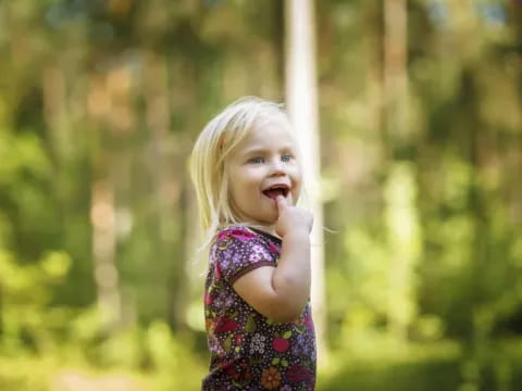 a little girl holding a stick