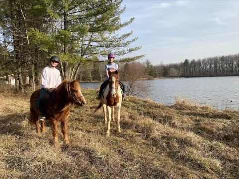 a couple of people ride horses