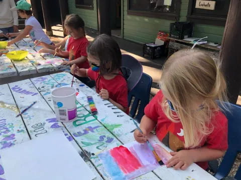 children painting on a table