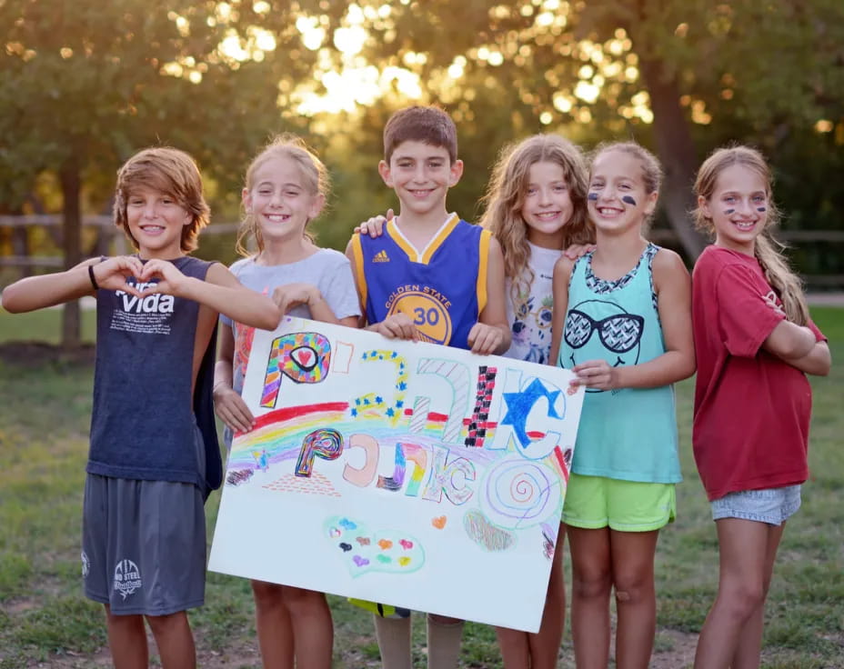 a group of children holding a sign