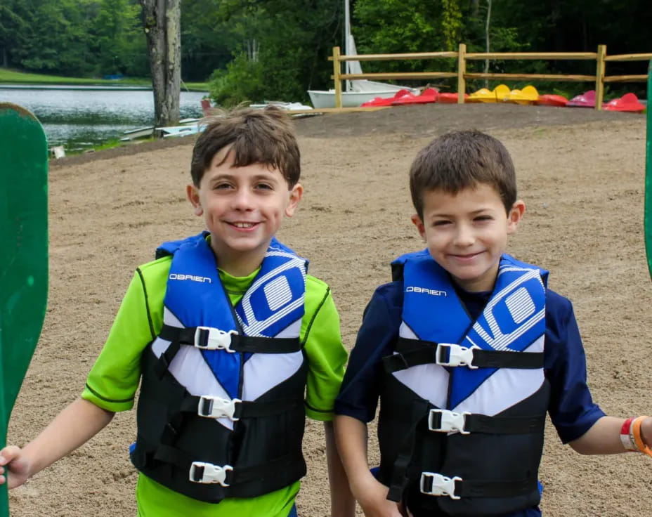 two boys holding paddles