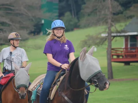 a couple of people ride horses