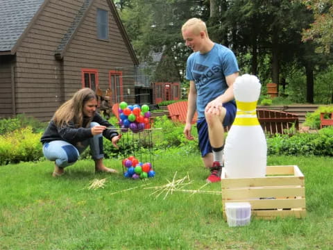 a boy and girl playing with balls