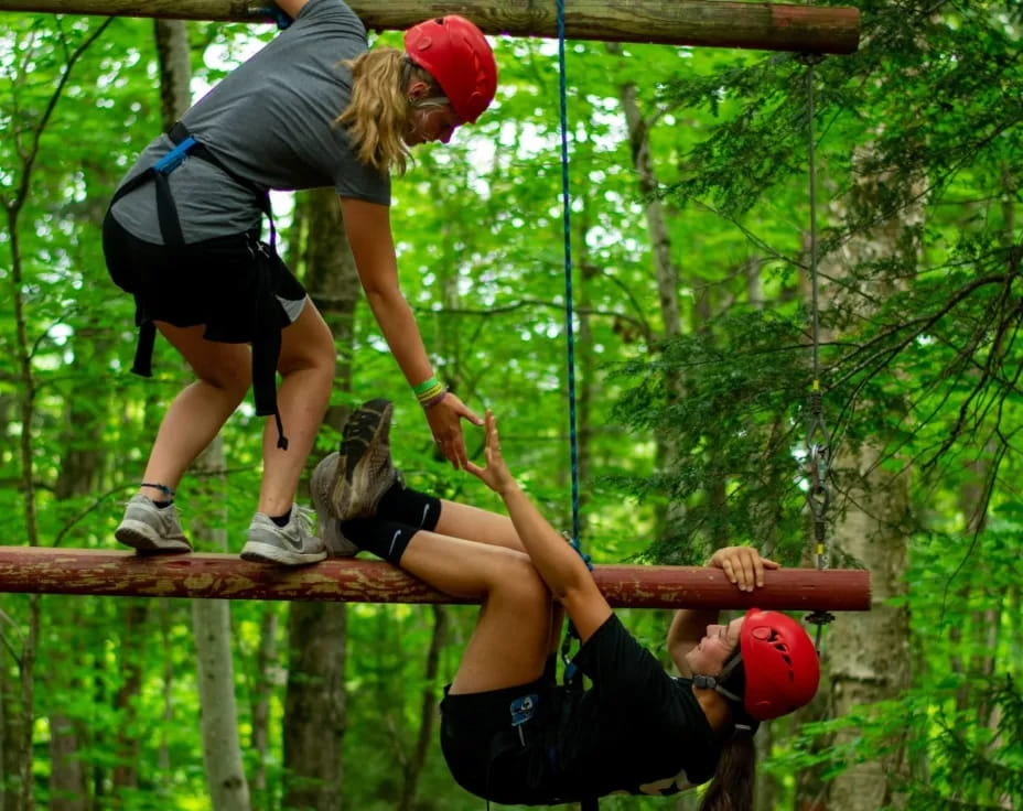 a group of people climbing a rope