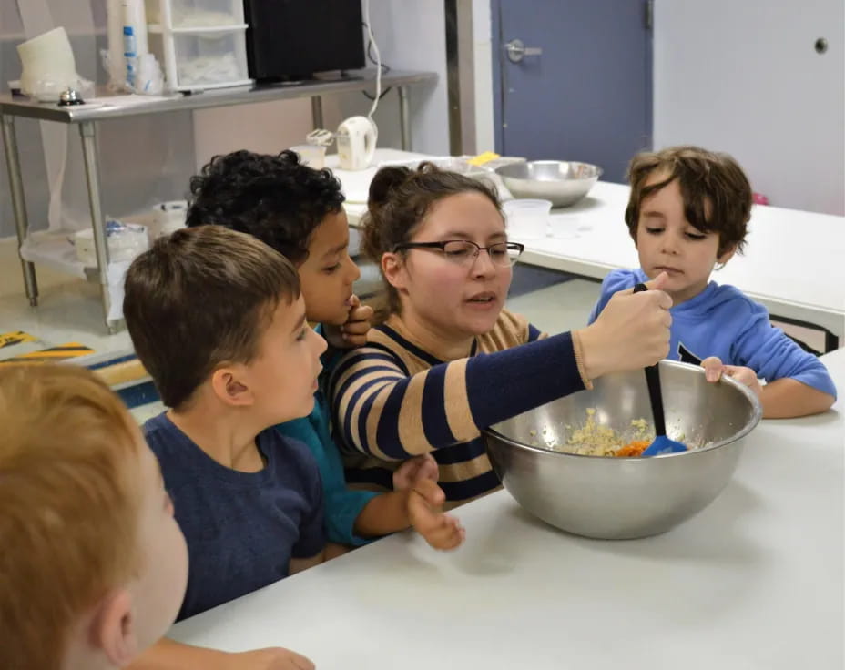 a group of boys eating from a bowl